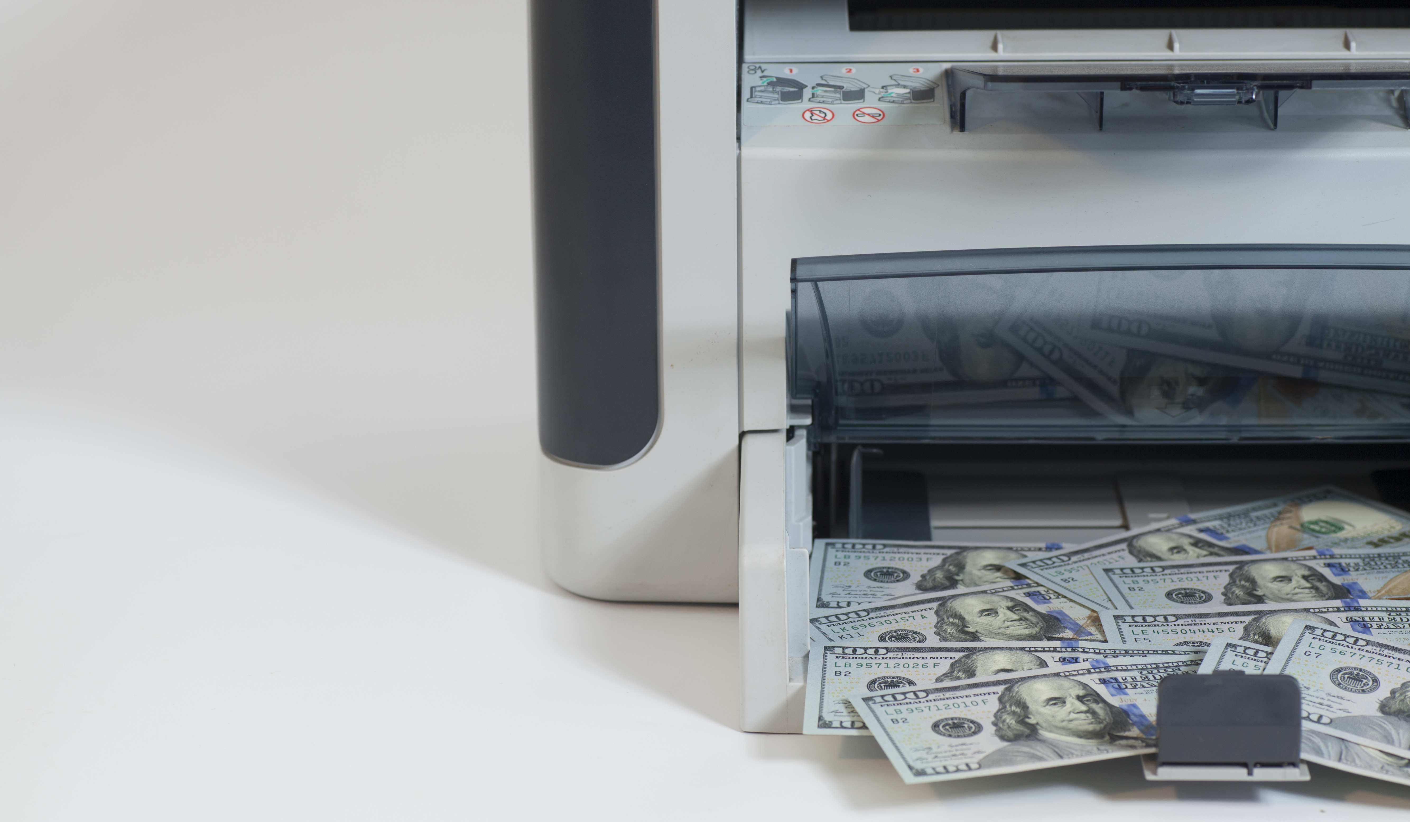 dollar bills coming out of a printer